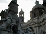 There's a legend that Bernini hated the facade of the church of S. Agnese in the background.  The facade was designed by a former student and rival of Bernini, Borromini. This explains that the statue of the Nile River hides its head to avoid seeing the Borromini facade, and that of the Ro de la Plata raises its arm in alarm to prevent the building from falling. The fountain was, in fact, unveiled in 1651, a year before the church of S. Agnese was begun, two years before Borromini was called in.
