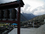 The view from the steps was wonderful: the roofs of the houses - full of wood and decorated with prayer flags, the green fields around town, and occasionally the mountains in the background.