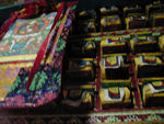 Thanka and holy books.  Thanka means, in Tibetan, "thing you roll up."   So, it's a picture, usually of a god, painted on cloth.  
