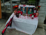 A shrine with pictures of the the former King and Queen