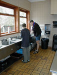 Mark and Tote do the dishes in the spotless Crianlarich hostel
